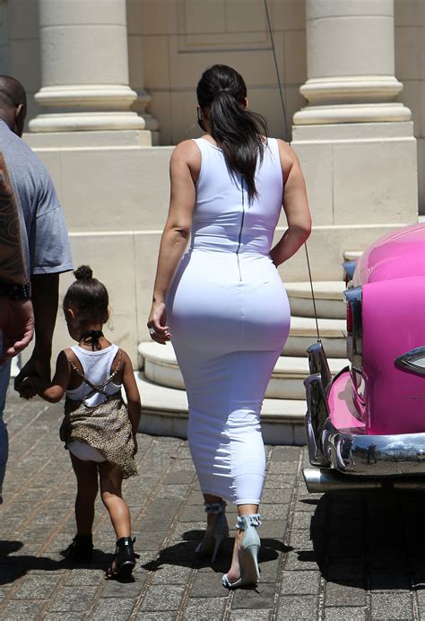 bootylicious kim kardashian exposes larger than ever butt in sexy skintight white dress ok