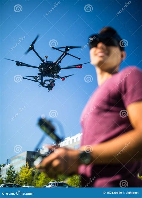 handsome young man flying  drone outdoors stock photo image  camera controller