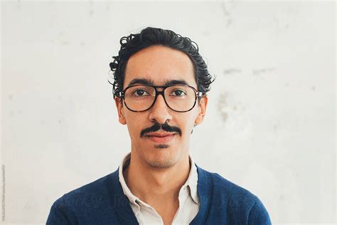 headshot  young handsome mexican man  glasses  stocksy