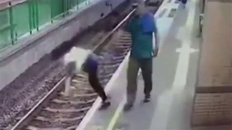 [watch] Cctv Footage Of Man Casually Pushing Woman Onto Railway Tracks