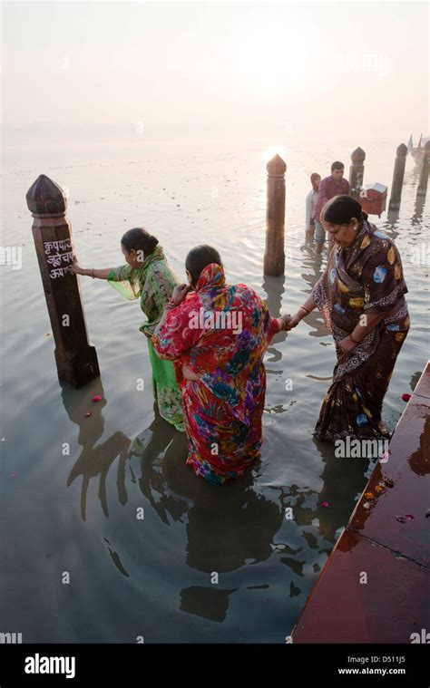 hindu devotees practice ritual bathing   sun rises   stock