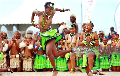 zulu dancers and singers dressed in traditionnal outfits perform