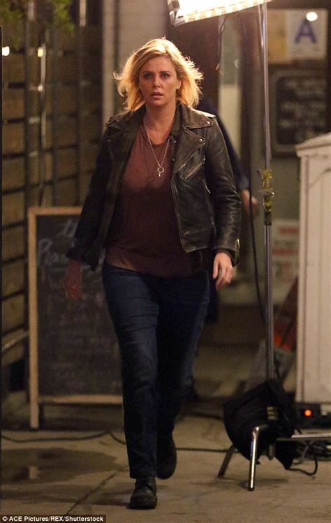 charlize theron shows fuller figure while riding a bike on