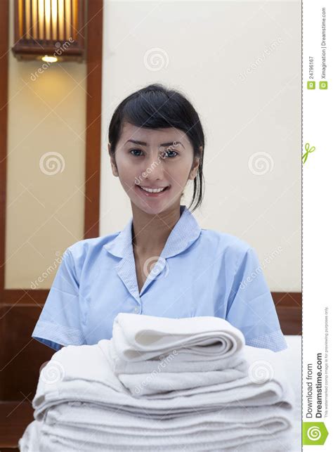 Hotel Maid With Towels Posing In A Hotel Room Stock Image
