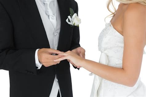 Premium Photo Bridegroom Putting The Wedding Ring On His Wifes Finger