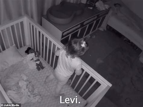 adorable big brother helps sister climb out of her crib and then