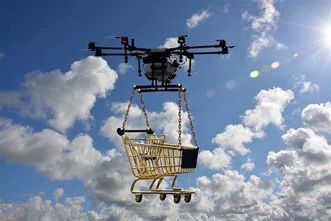 white black drone lifting yellow shopping cart daytime logistics drone piqsels