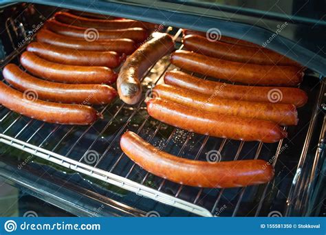 cooking sausages in the oven fast food street fried sausages stock