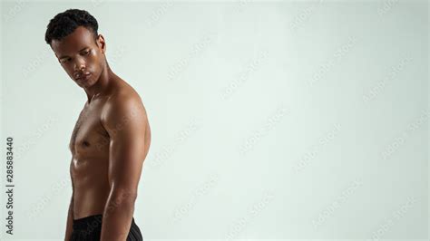 perfect body side view  young shirtless muscular african man