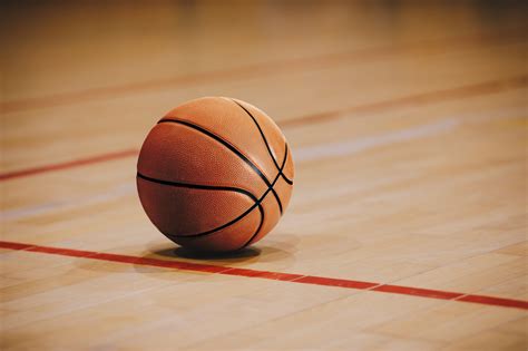 classic basketball  wooden court floor close   blurred arena  background orange ball