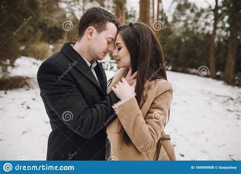 Gorgeous Wedding Couple Hugging In Winter Snowy Park Stylish Bride In