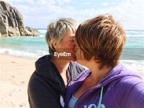 Lesbian Couple Kissing At Beach On Sunny Day Id 108936464