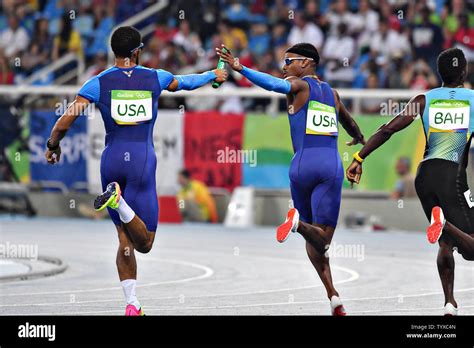 Members Of The United States Relay Team Hand Off The Baton During The
