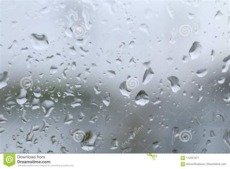 water drop on glass window and rain condensation rainy storm season