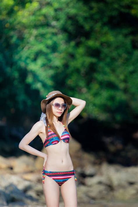 mooie jonge aziatische vrouw in bikini het ontspannen op het strand de