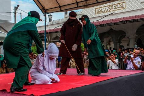 horrific pictures show woman being savagely whipped by masked sharia law enforcer for having