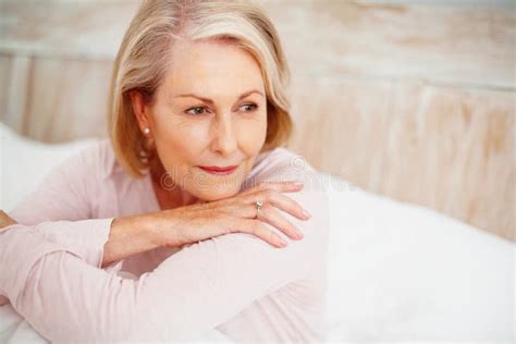Relaxed Mature Woman In Bed Looking Away Closeup Portrait Of A Relaxed