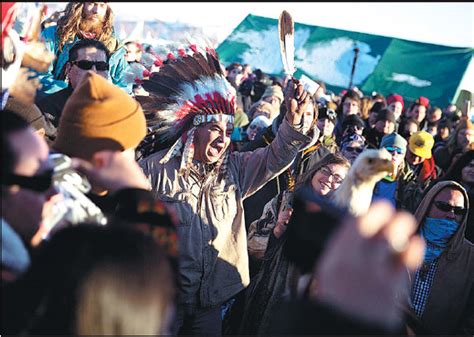 a crowd gathers in celebration at the oceti sakowin camp