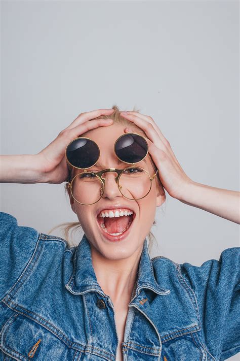 funny portrait of a blonde woman with glasses by stocksy contributor