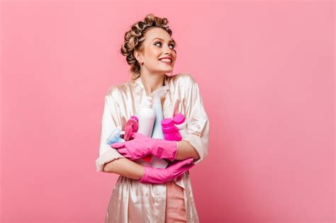Free Photo Joyful Housewife Woman In Pink Robe Holding Detergent