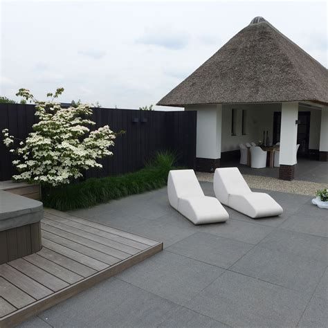 moderne tuin lounge bedden tuin jacuzzi houten vlonder boerderij rietenkap terras tegels