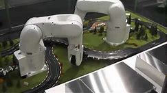 DENSO Robotics - Robots lay out slot-car track
