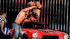 John Cena throws Batista onto a car with an Attitude Adjustment