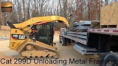 Cat 299D XHP Unloading the Framing for a 80x100 Metal Building