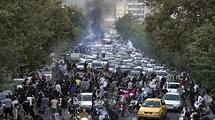At least 9 killed as Iran protests spread over woman's death