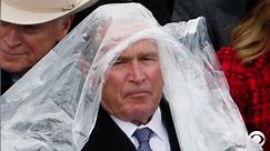 George W. Bush struggles with his poncho at Trump's inauguration