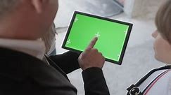 Sales agent holding ipad in new building. Man working as realtor in construction site with digital tablet monitor. Real estate broker showing green screen for internet website