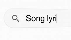 Songs lyrics is being typed in a search bar on a computer LCD monitor screen (Search results).