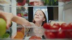 Young Girl Opening Fridge with Diet Food of Fruits and Vegetables and Taking Ingredients to Eat. Kitchen Refrigerator of Healthy Child Cooking Evening Meal. Freezer Filled with Convenience Purchase