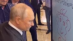 Putin, or at least a Putin double, scribbles a childish drawing at hi-tech forum