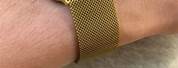 Black Apple Watch with Gold Milanese Band