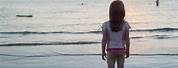 Teenage Girl Facing Ocean