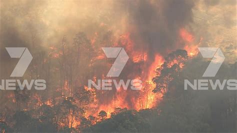 Roads closed as out of control bushfire threatens lives and homes in ...