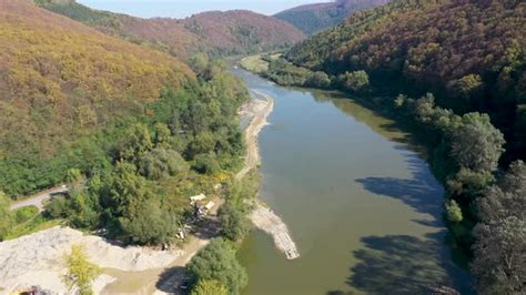 Aerial view of backhoes digging sand and gravel with shovels from the ...