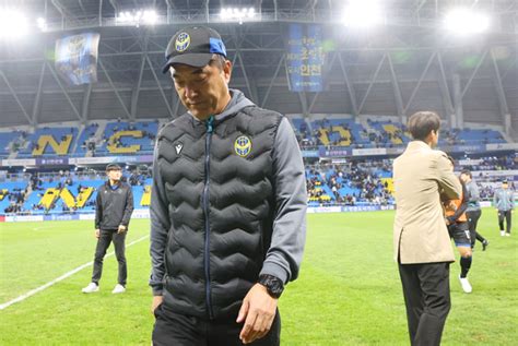 Incheon United manager Choi Young-keun walks off the pitch after his ...