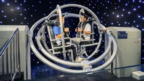 People try rotating space simulator machine inside China museum