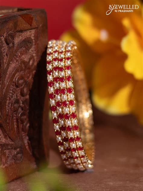Pearl rajawadi bangles with ruby stones and pearls in gold finish ...