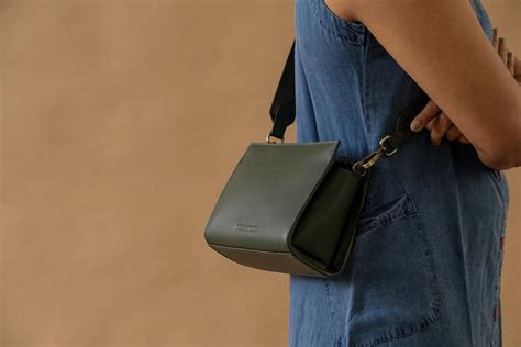 Clean lines, utilitarian look and genuine leather take over this label ...