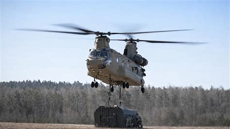 US Army helicopter lifts heavy cargo using sling load