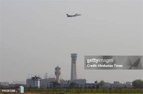A passenger aircraft seen flying over new ATC Tower at Terminal 3 of ...
