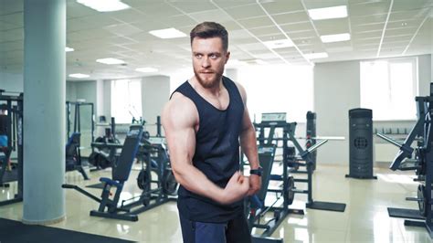 Muscular bodybuilder showing strong biceps on arm. Confident macho ...