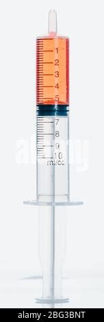 Medical syringe with blood, ampule and pills on yellow background Stock ...