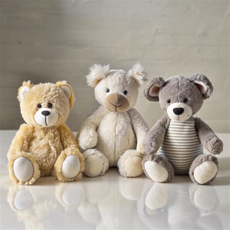 Three stuffed animals sit next to each other on a table | Premium AI ...