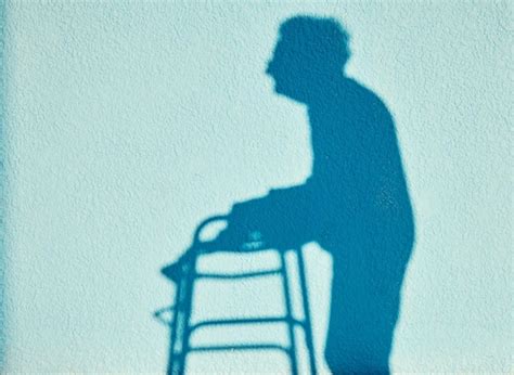 Shadow disability and walking with a senior woman outdoor on a blue ...