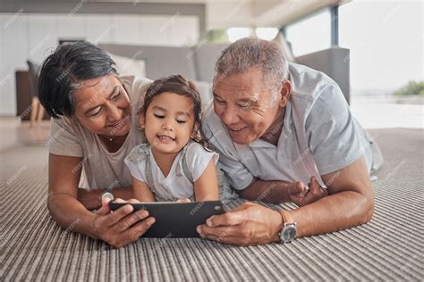 Premium Photo | Relax grandparents and cartoon on tablet with child on ...