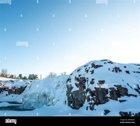 Sioux Falls Park during winter with frozen waterfall and snow cover ...
